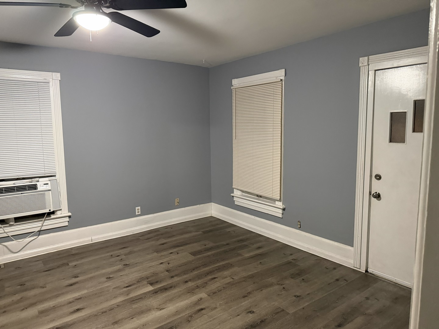 429 South Street, Unit 1 Elgin, IL 60123 - Photo 2 of 17 an empty room with wooden floor and windows