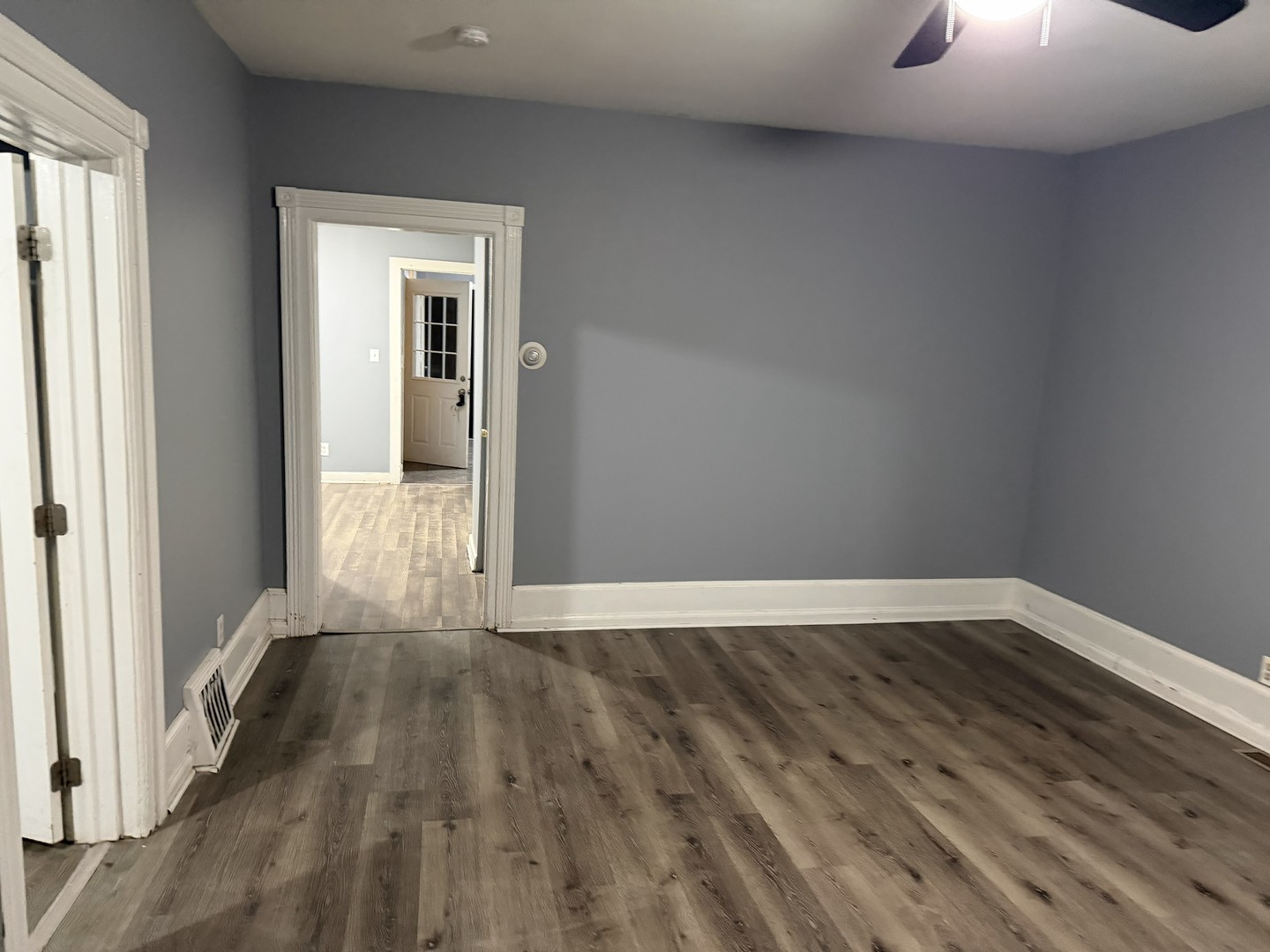 429 South Street, Unit 1 Elgin, IL 60123 - Photo 3 of 17 a view of an empty room with wooden floor and a window