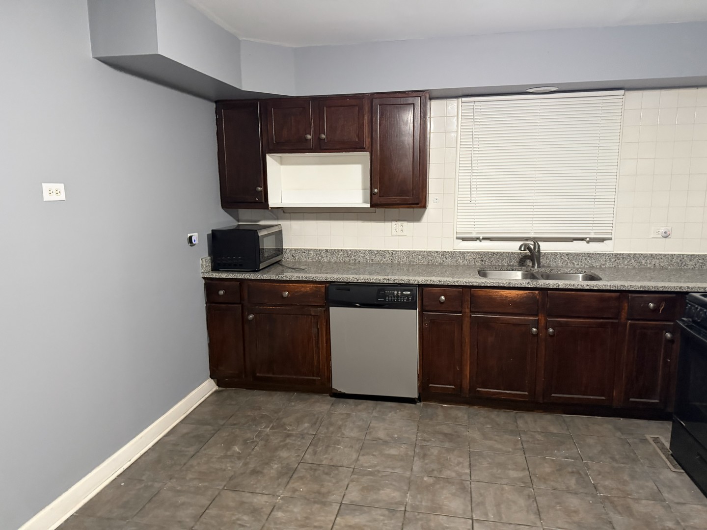 429 South Street, Unit 1 Elgin, IL 60123 - Photo 4 of 17 a kitchen with a sink and a wooden cabinets