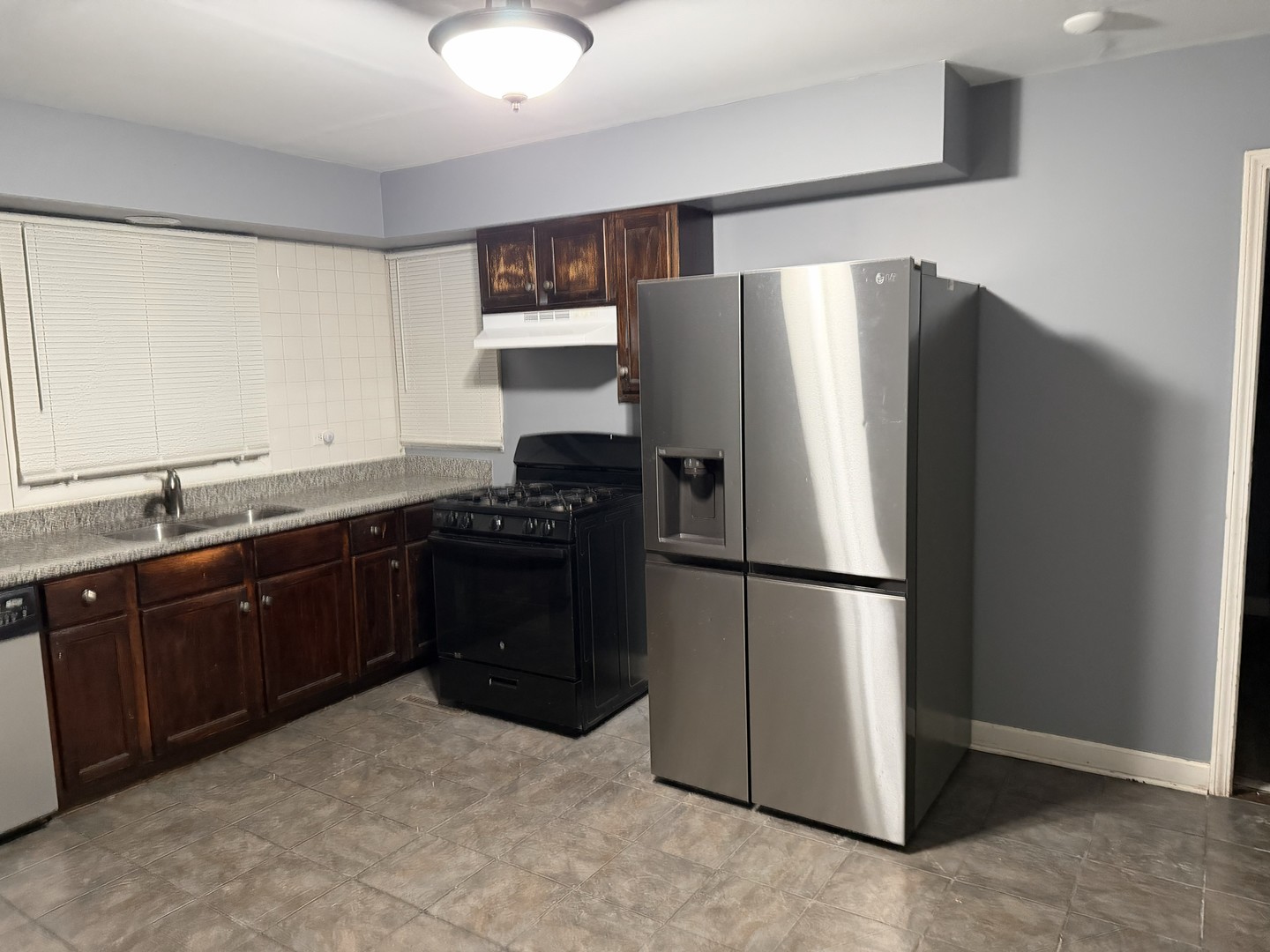 429 South Street, Unit 1 Elgin, IL 60123 - Photo 5 of 17 a kitchen with a refrigerator and a sink