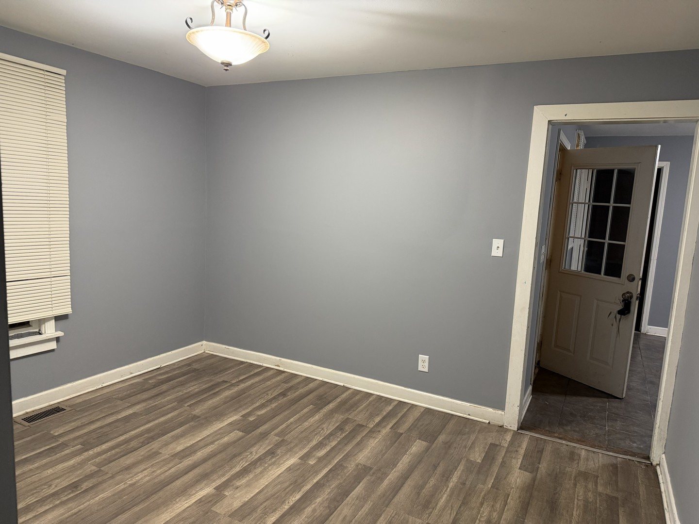 429 South Street, Unit 1 Elgin, IL 60123 - Photo 7 of 17 wooden floor in an empty room with a window