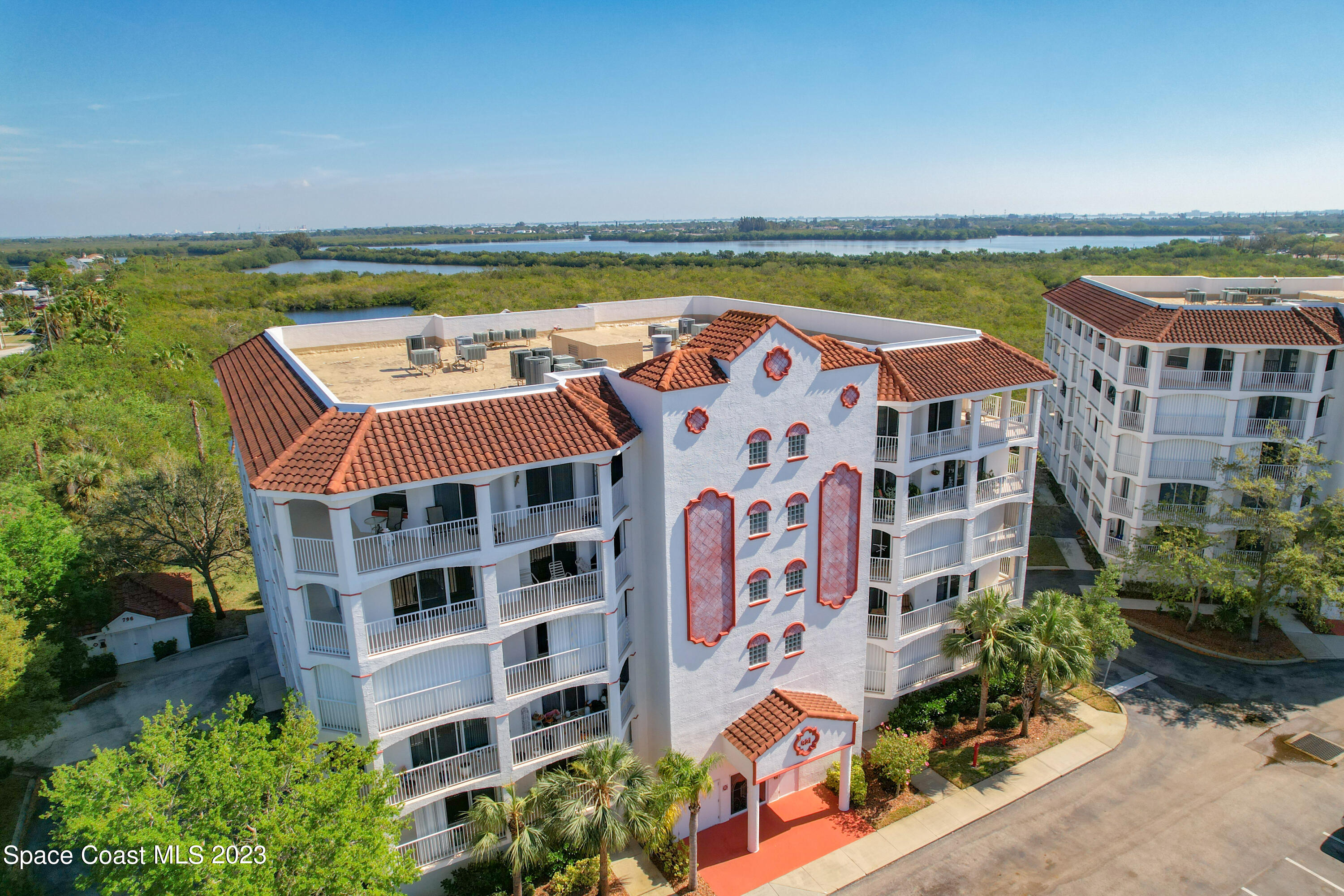 an aerial view of residential building with outdoor space and seating