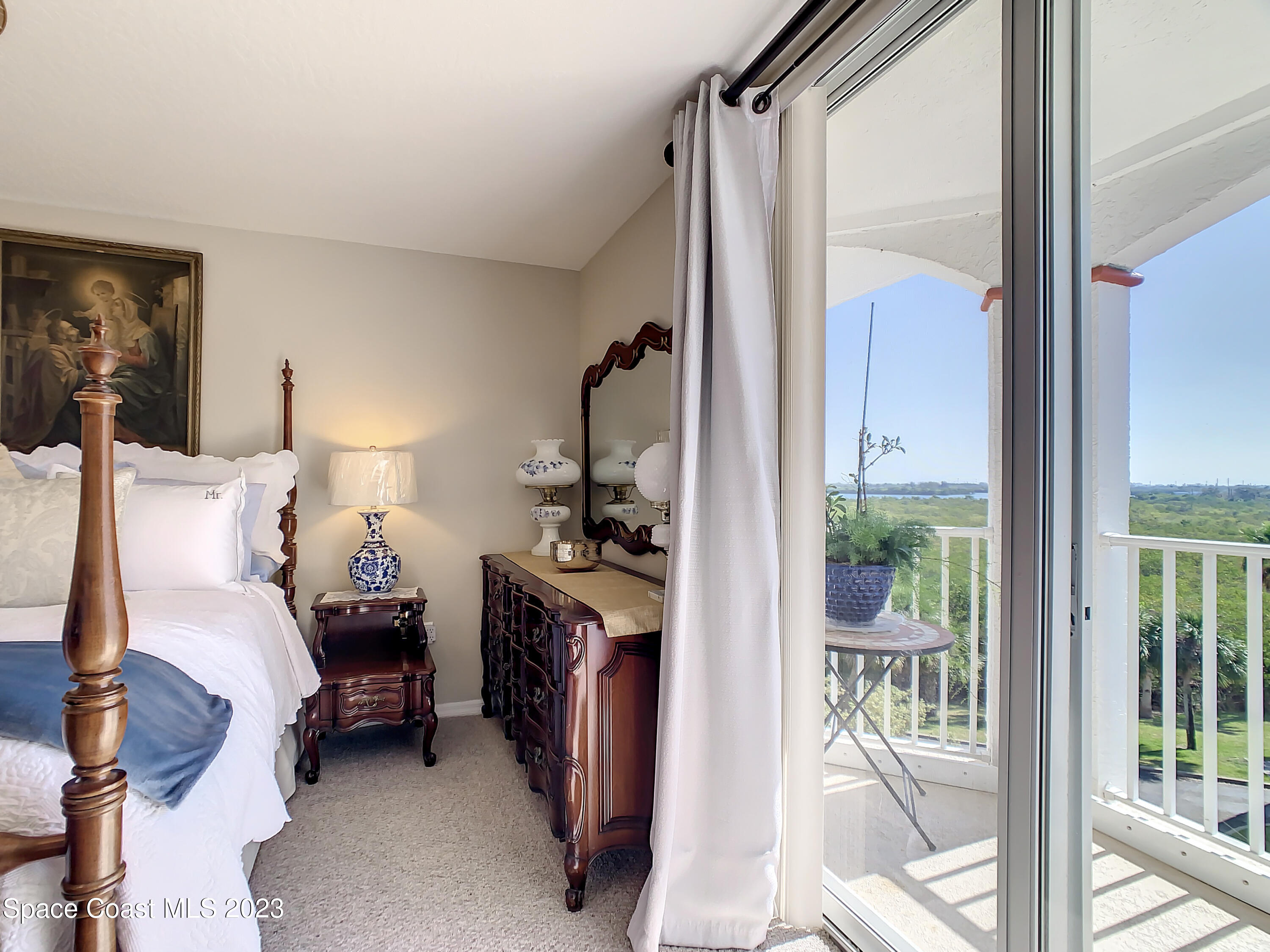 821 Del Rio Way, Unit 504 Merritt Island, FL 32953 - Photo 16 of 37 a bedroom with a bed and a mirror