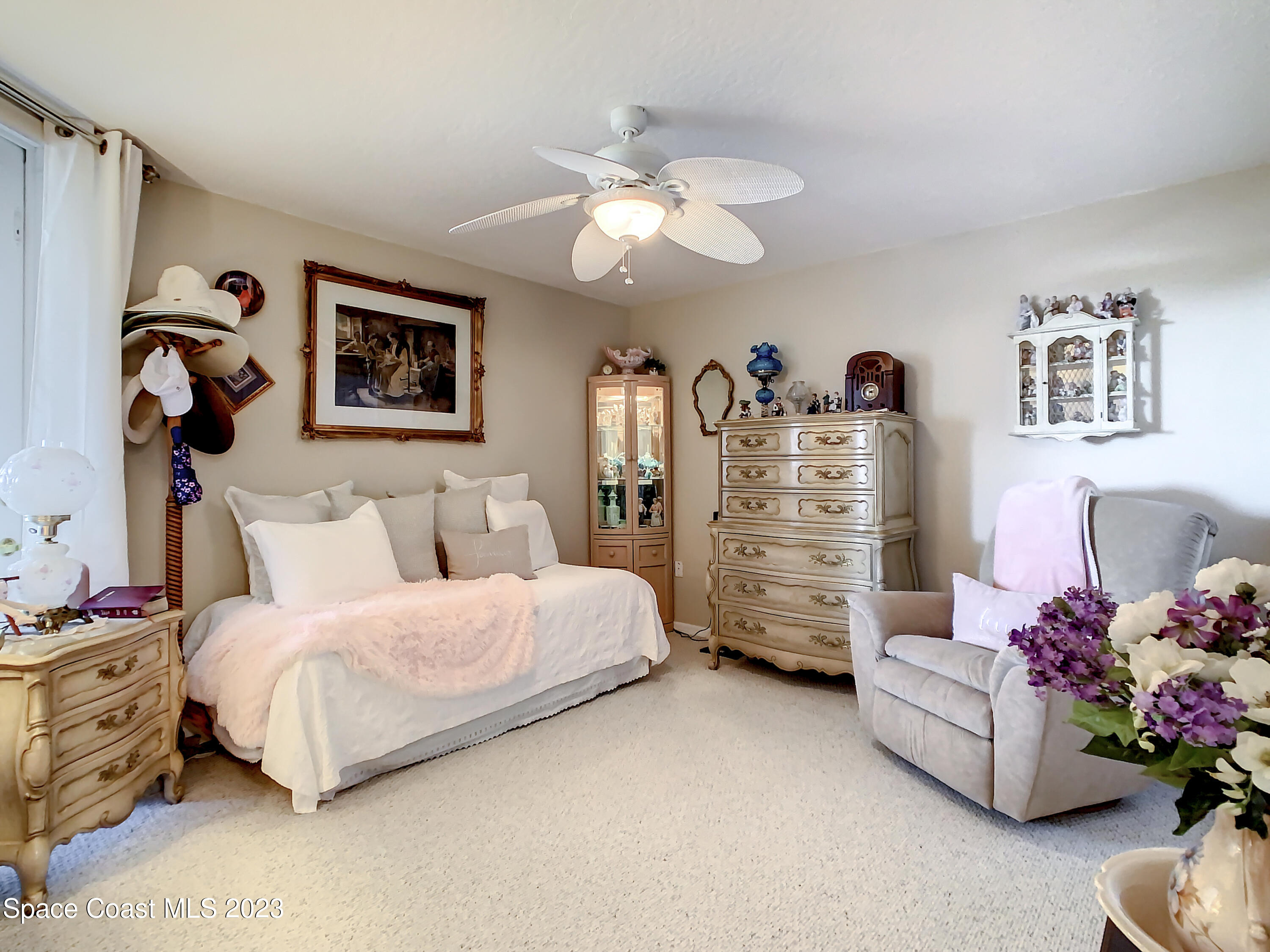 821 Del Rio Way, Unit 504 Merritt Island, FL 32953 - Photo 19 of 37 a bedroom with bed and a chandelier