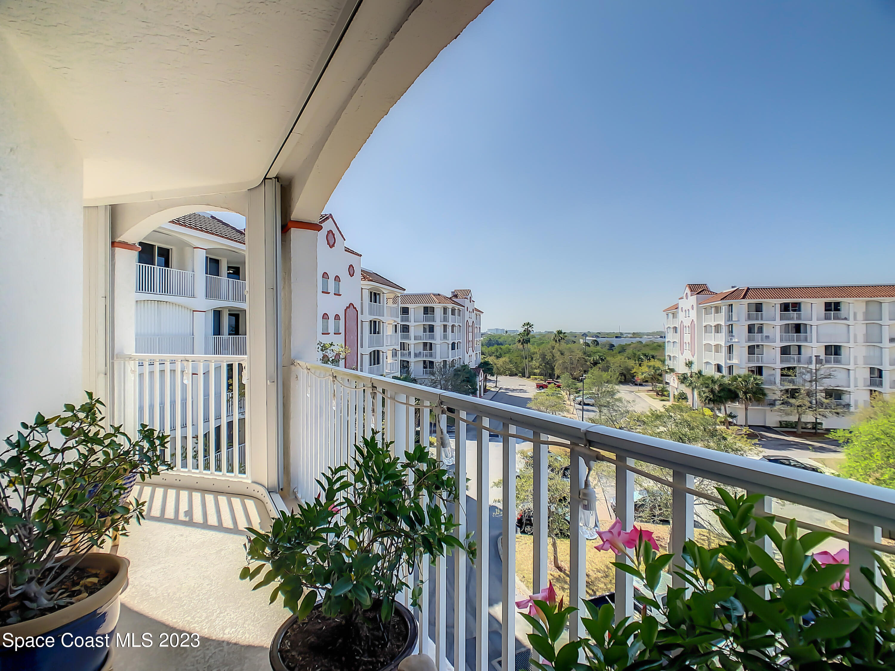 821 Del Rio Way, Unit 504 Merritt Island, FL 32953 - Photo 23 of 37 a view of a balcony with flower plants
