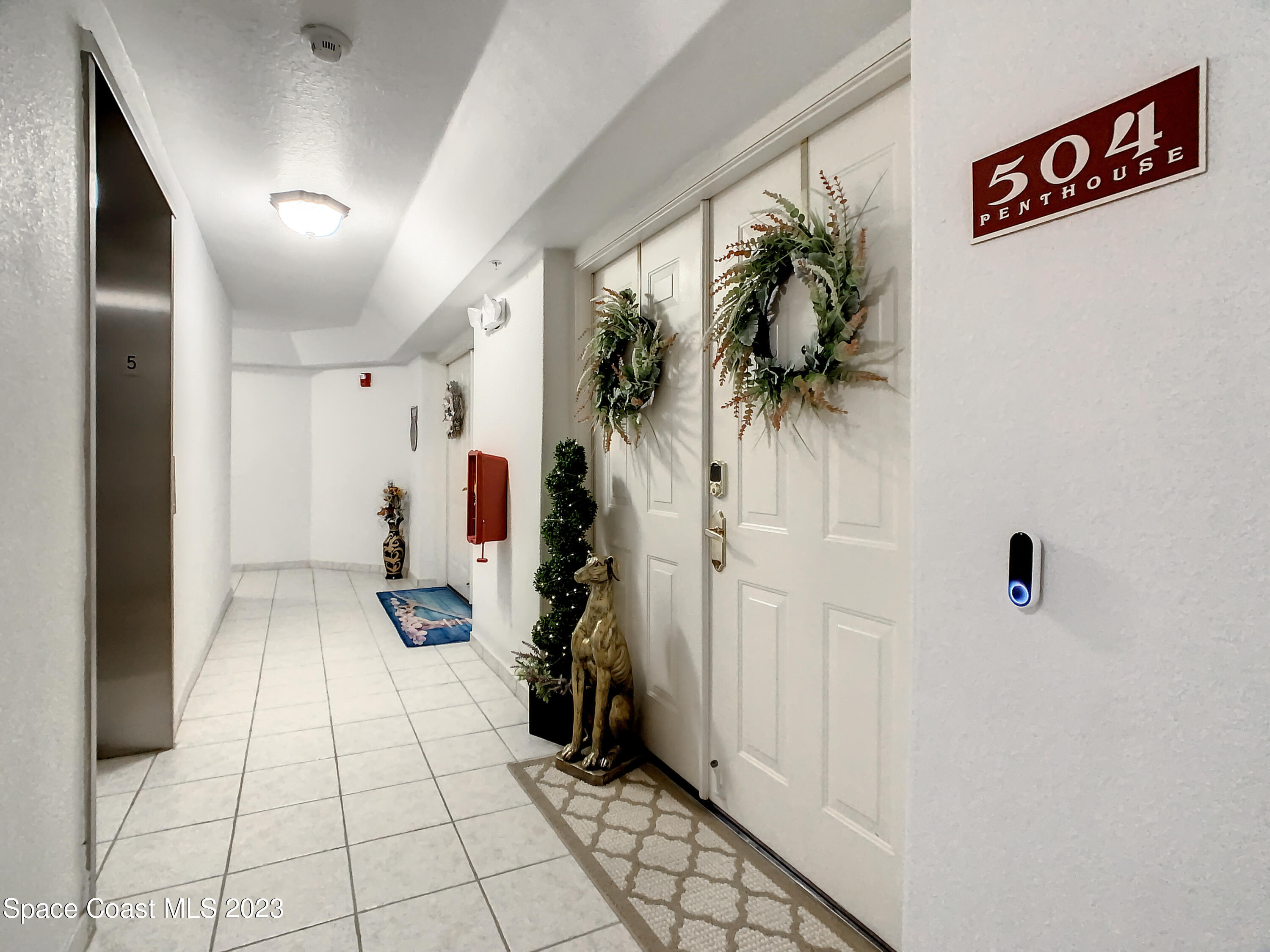 821 Del Rio Way, Unit 504 Merritt Island, FL 32953 - Photo 3 of 37 Double doors to penthouse