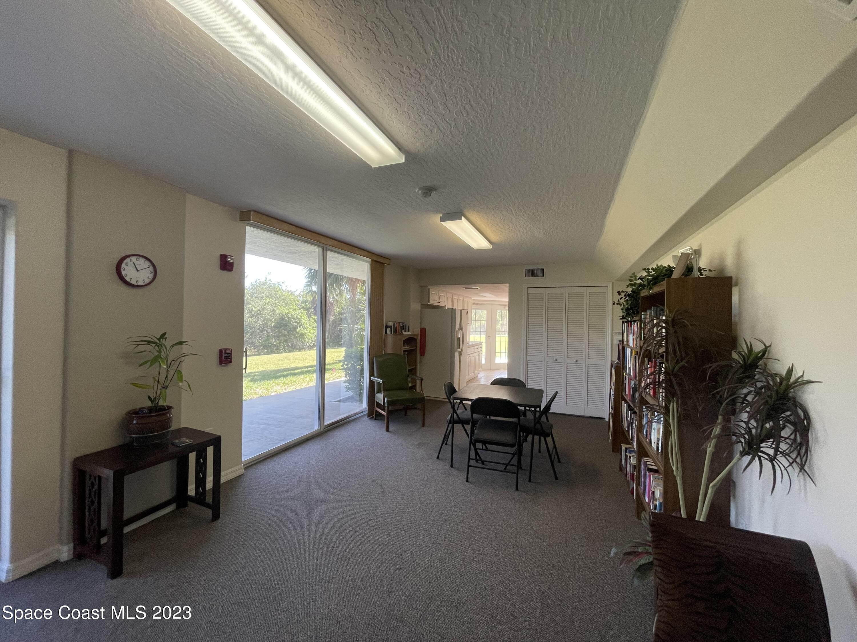 821 Del Rio Way, Unit 504 Merritt Island, FL 32953 - Photo 32 of 37 a view of a livingroom with furniture and floor to ceiling window