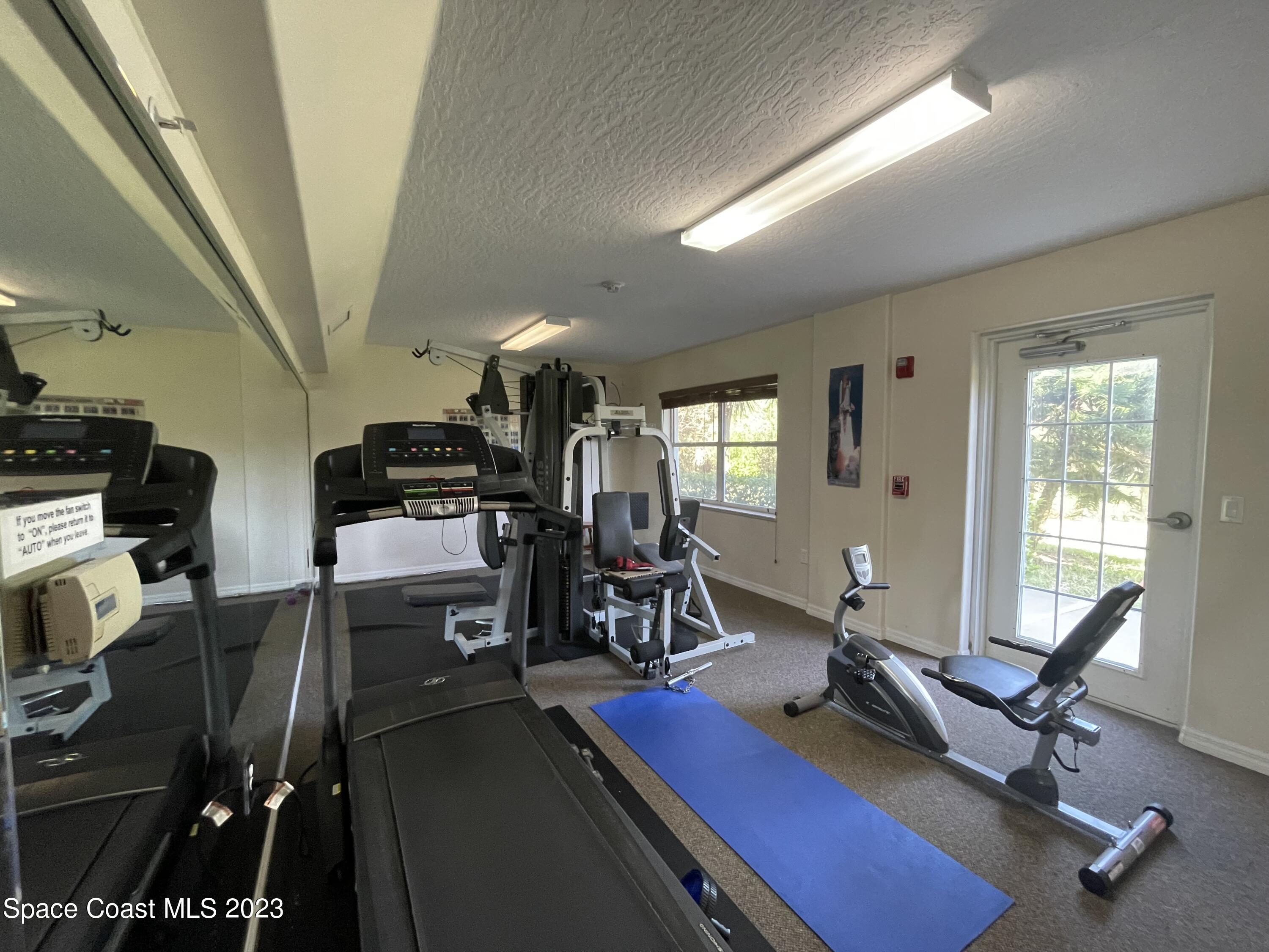 821 Del Rio Way, Unit 504 Merritt Island, FL 32953 - Photo 33 of 37 a view of a workspace with gym equipment