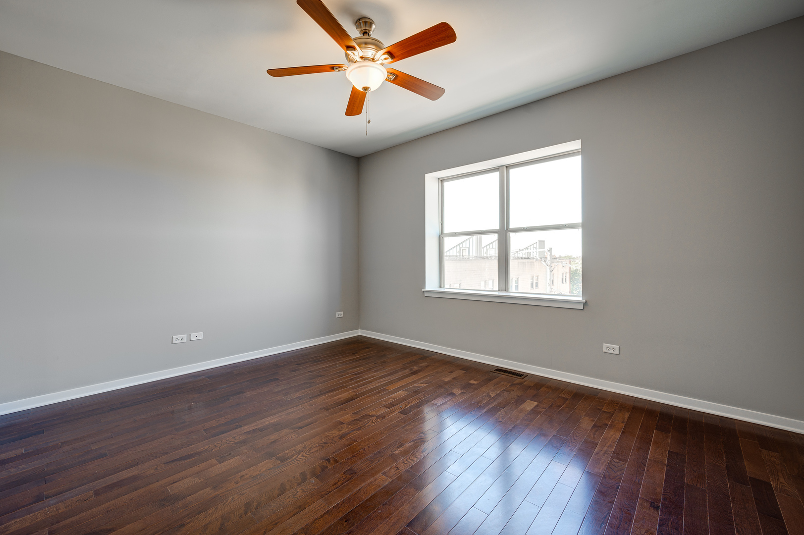 1038 South Racine Avenue, Unit 301 Chicago, IL 60607 - Photo 13 of 24 an empty room with wooden floor and windows