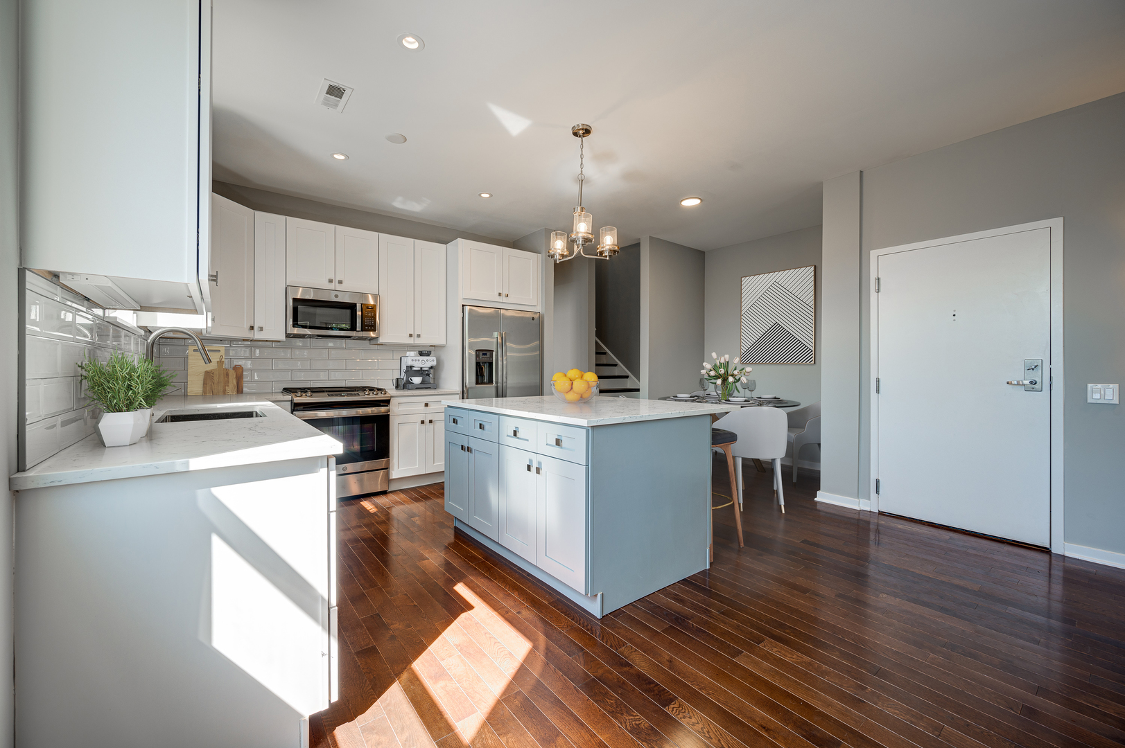 1038 South Racine Avenue, Unit 301 Chicago, IL 60607 - Photo 5 of 24 a kitchen with kitchen island granite countertop a sink cabinets and stainless steel appliances