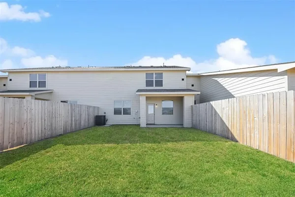 a view of a house with a yard and deck