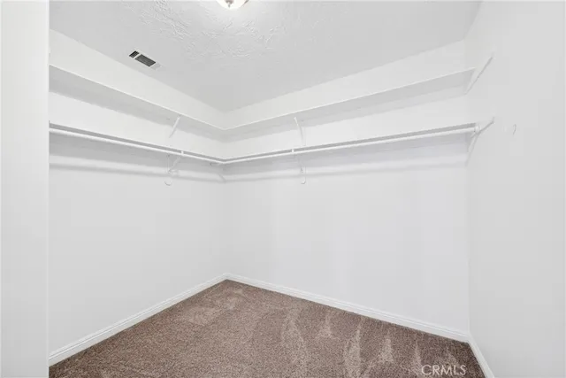 an empty room with ceiling fan and window