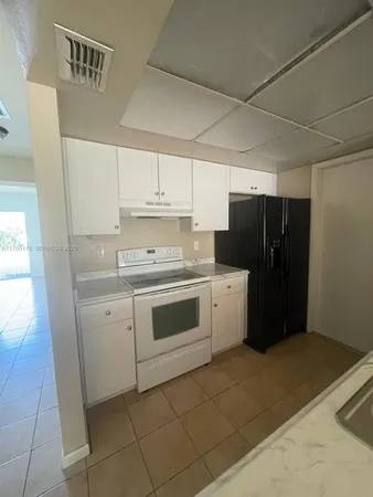 a kitchen with a stove a refrigerator and a sink