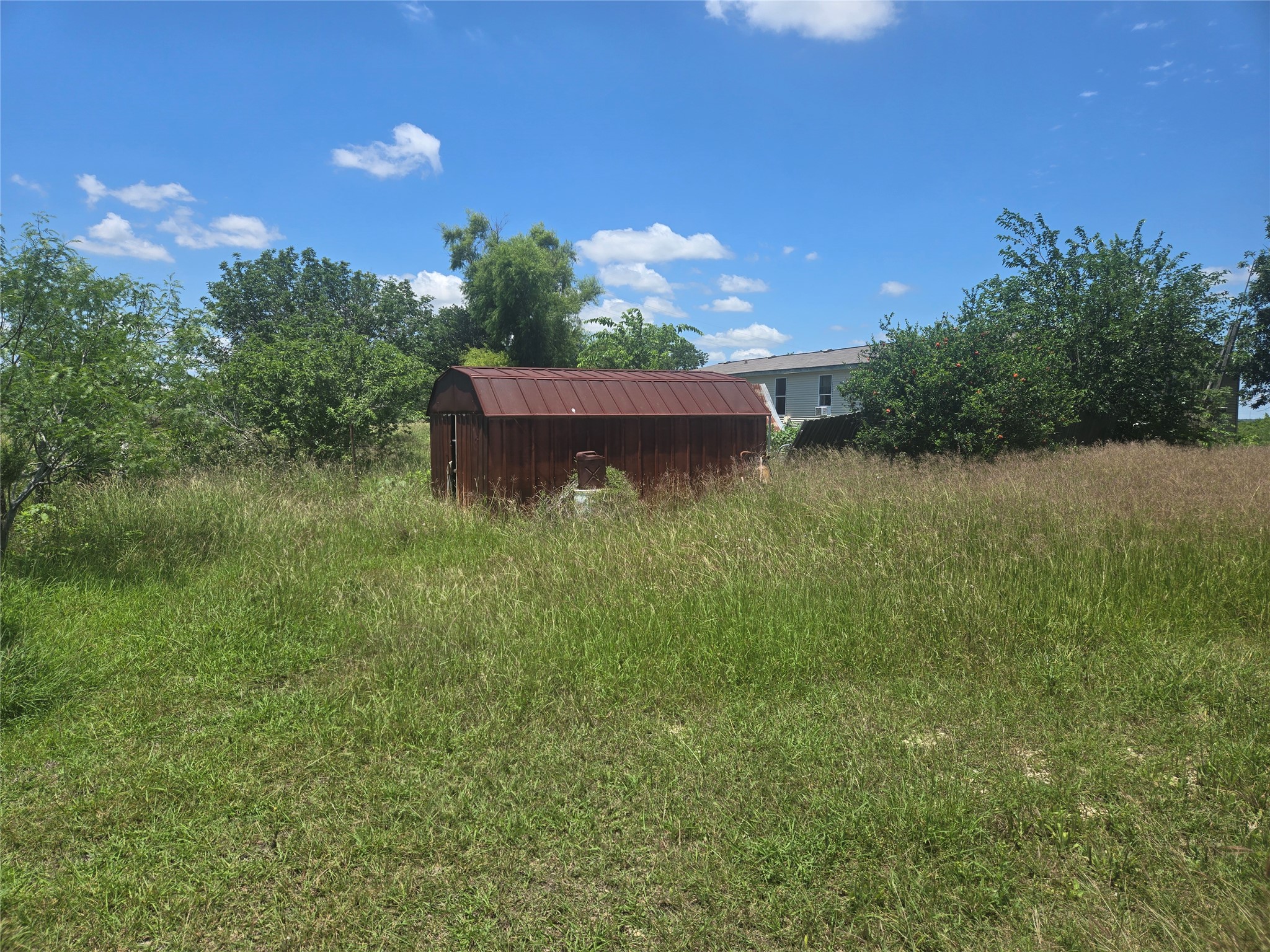 150 Longhorn Loop Kyle, TX 78640 - Photo 10 of 13 a view of a lake from a yard