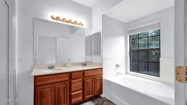 a spacious bedroom with a bed and a window