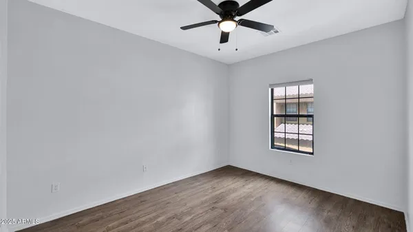 a bedroom with a large bed and a flat screen tv
