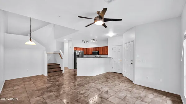a view of a livingroom with a ceiling fan and window