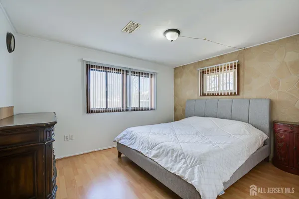 a bedroom with a bed and a window