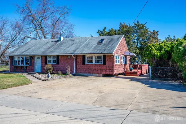 a front view of a house with yard patio and fire pit