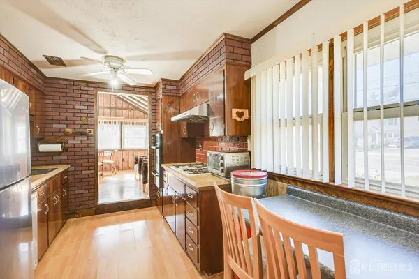 a dining room with furniture and a floor to ceiling window