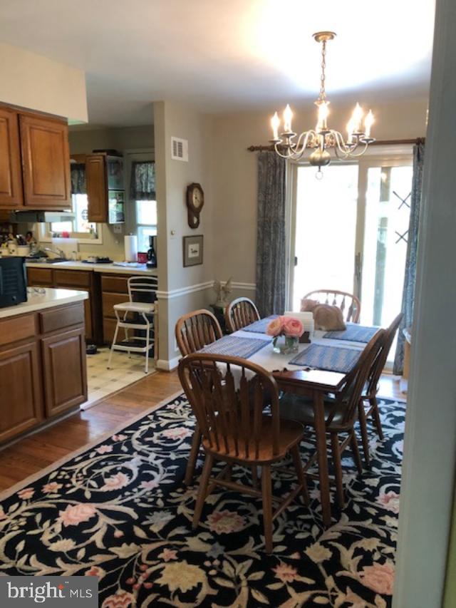 5221 Wyoming Road Bethesda, MD 20816 - Photo 13 of 24 DINING ROOM TO KITCHEN WITH SLIDING DOORS TO PATIO