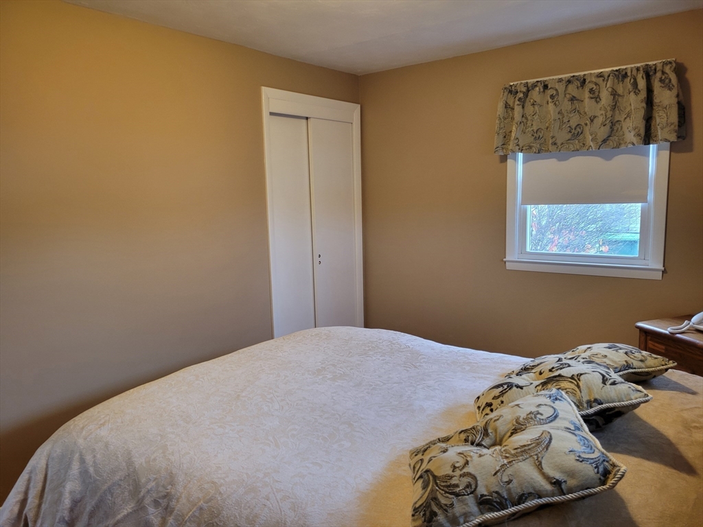 39 Daley Street Chicopee, MA 01013 - Photo 11 of 17 a bedroom with a bed and a painting on the wall