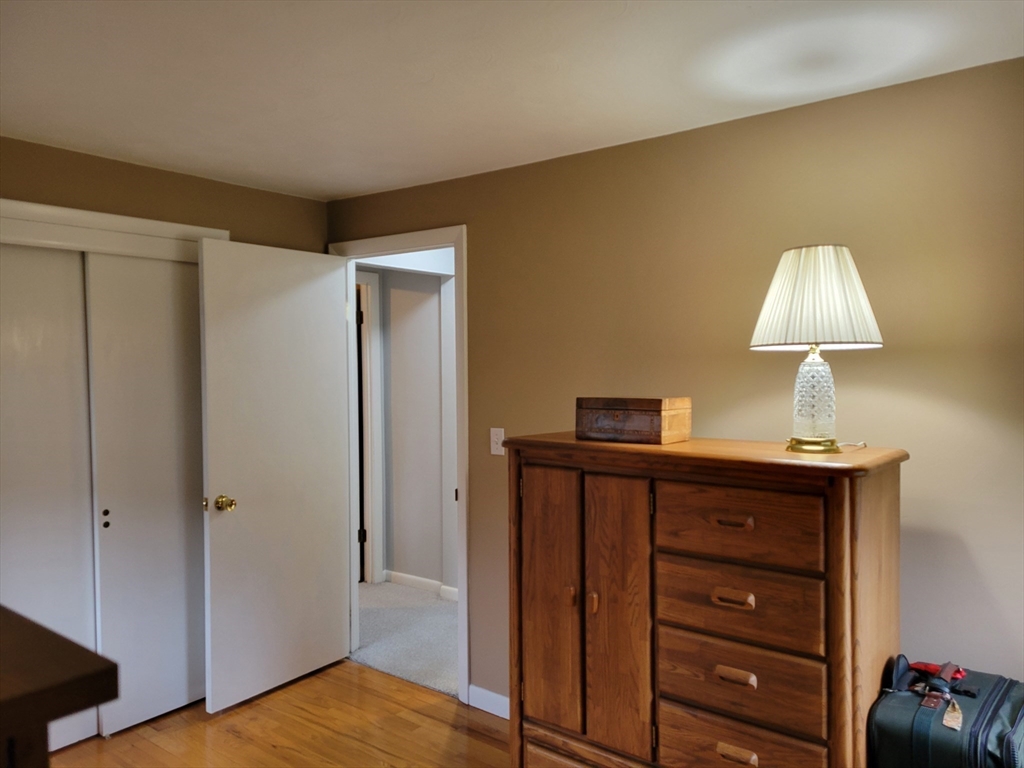 39 Daley Street Chicopee, MA 01013 - Photo 15 of 17 a view of a bedroom with a dresser and a lamp
