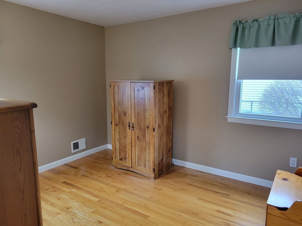 39 Daley Street Chicopee, MA 01013 - Photo 16 of 17 a view of an empty room with wooden floor and a window