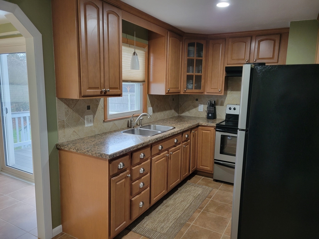 39 Daley Street Chicopee, MA 01013 - Photo 3 of 17 a kitchen with stainless steel appliances granite countertop a refrigerator a stove and a sink