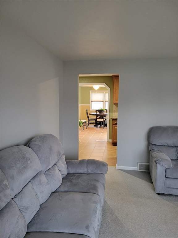 39 Daley Street Chicopee, MA 01013 - Photo 7 of 17 a living room with furniture and a bathroom