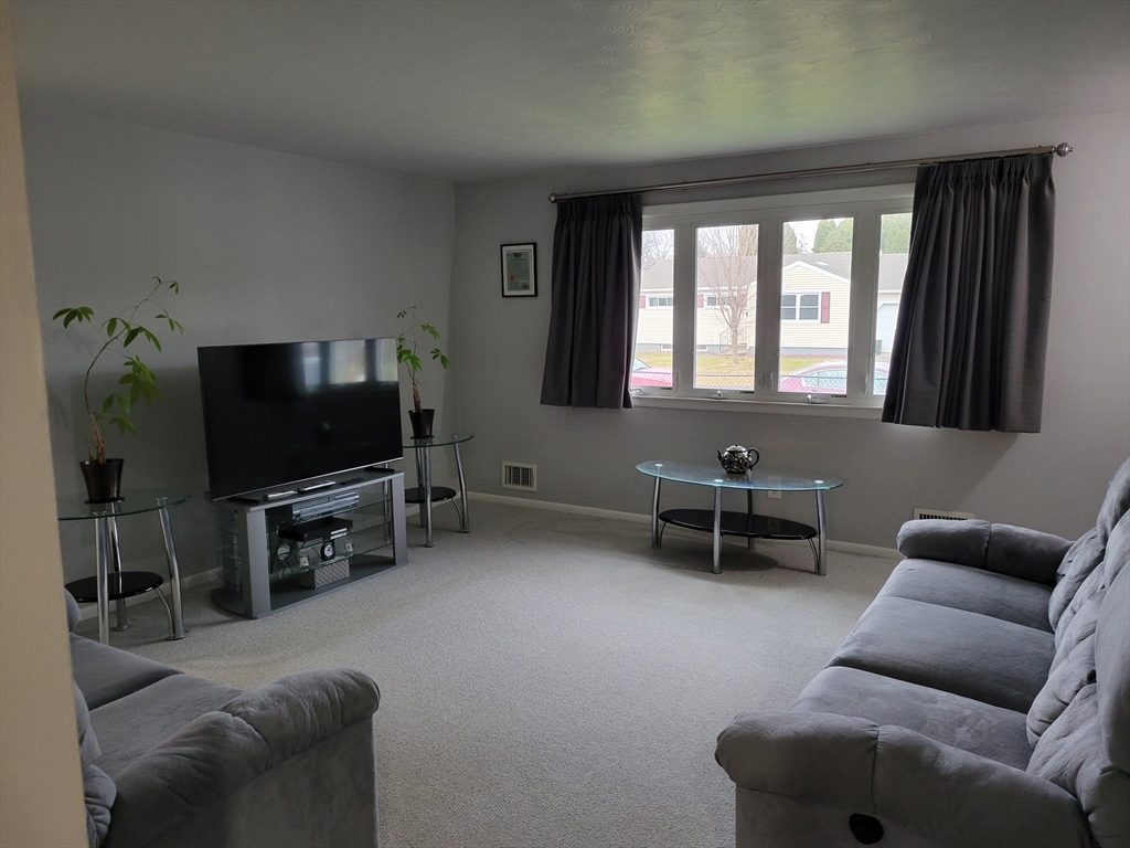 39 Daley Street Chicopee, MA 01013 - Photo 9 of 17 a living room with furniture and a flat screen tv