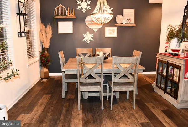 a view of a dining room with furniture and chandelier
