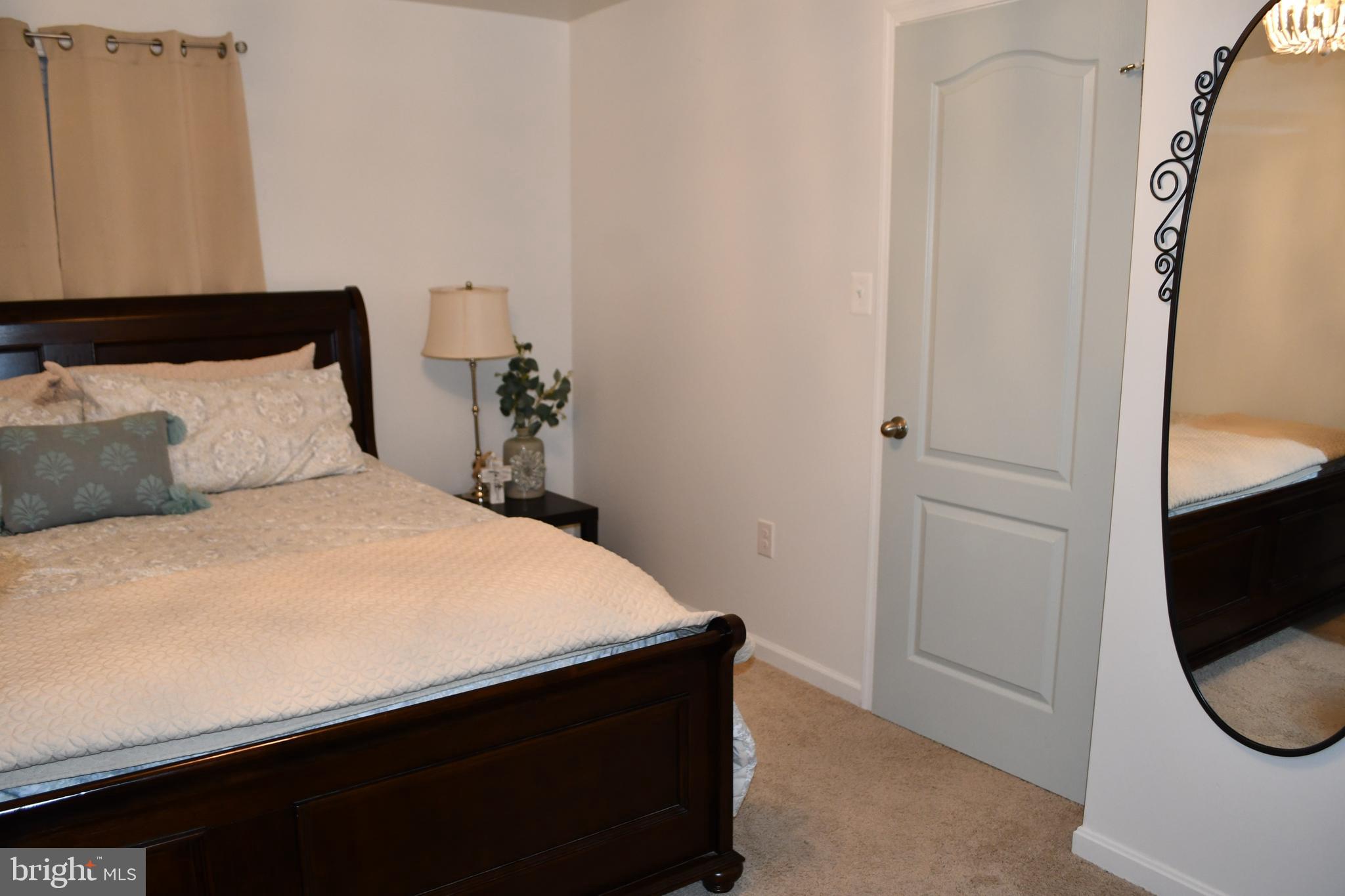 848 Chestnut Ridge Drive Magnolia, DE 19962 - Photo 29 of 38 a bedroom with a bed and a mirror