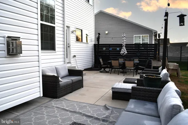 a view of a house with swimming pool and sitting area