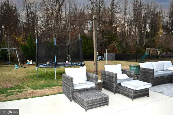 a view of a house with swimming pool and sitting area