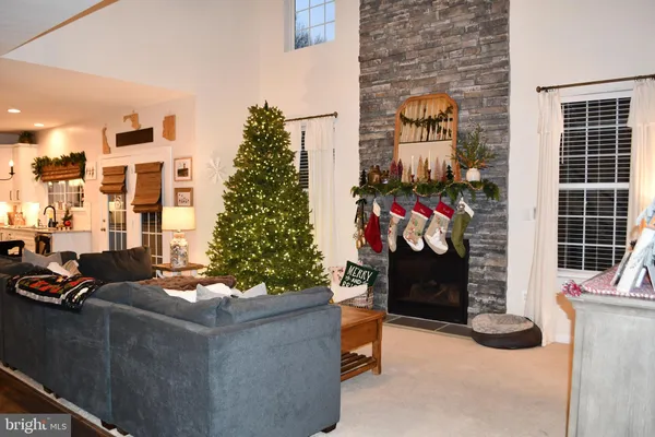 a living room with fireplace furniture and a flat screen tv