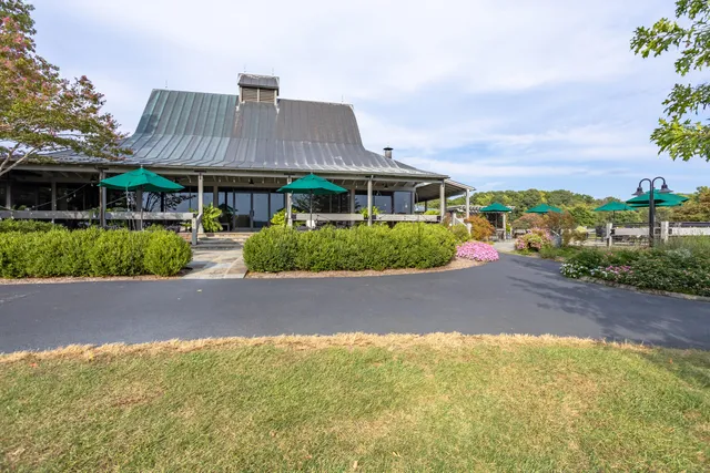 a front view of house with yard and trees around