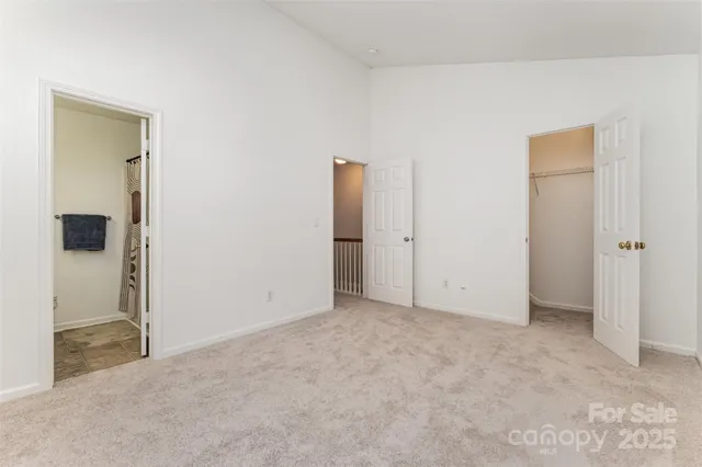 an empty room with closet and mirror