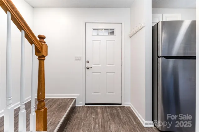 a view of a refrigerator in kitchen and wooden floor