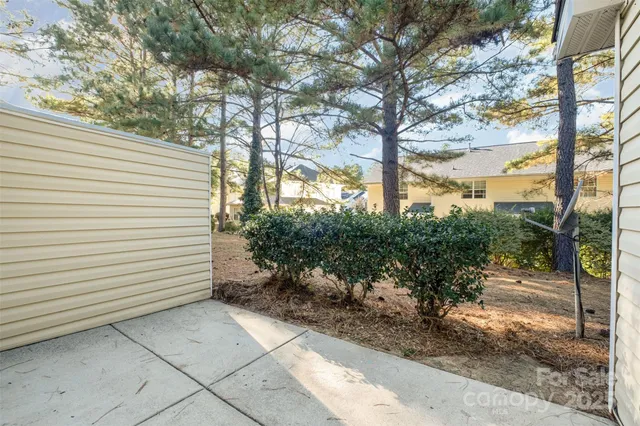 a front view of a house with a yard and potted plants