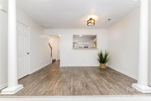a view of a room with wooden floor and window