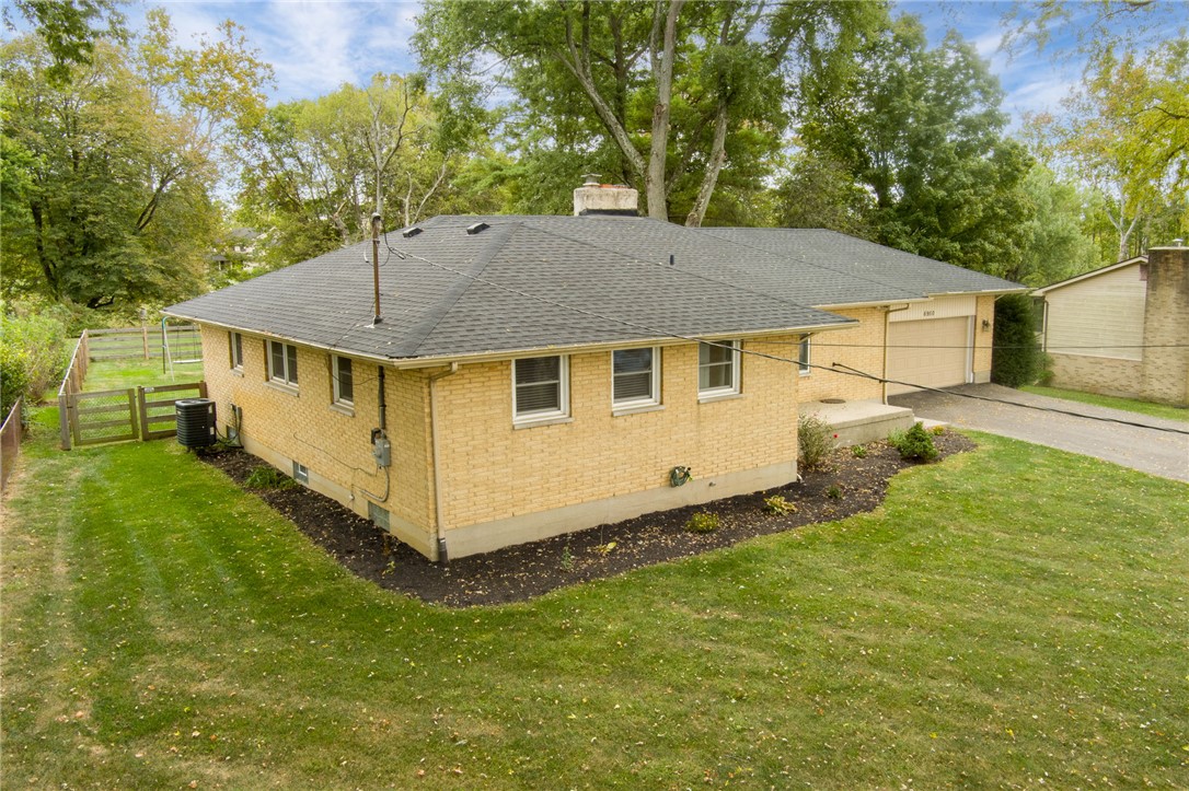 6950 Red Lion 5 Points Road Springboro, OH 45066 - Photo 68 of 78 This charming brick home is nestled amidst lush greenery, offering a serene suburban retreat.