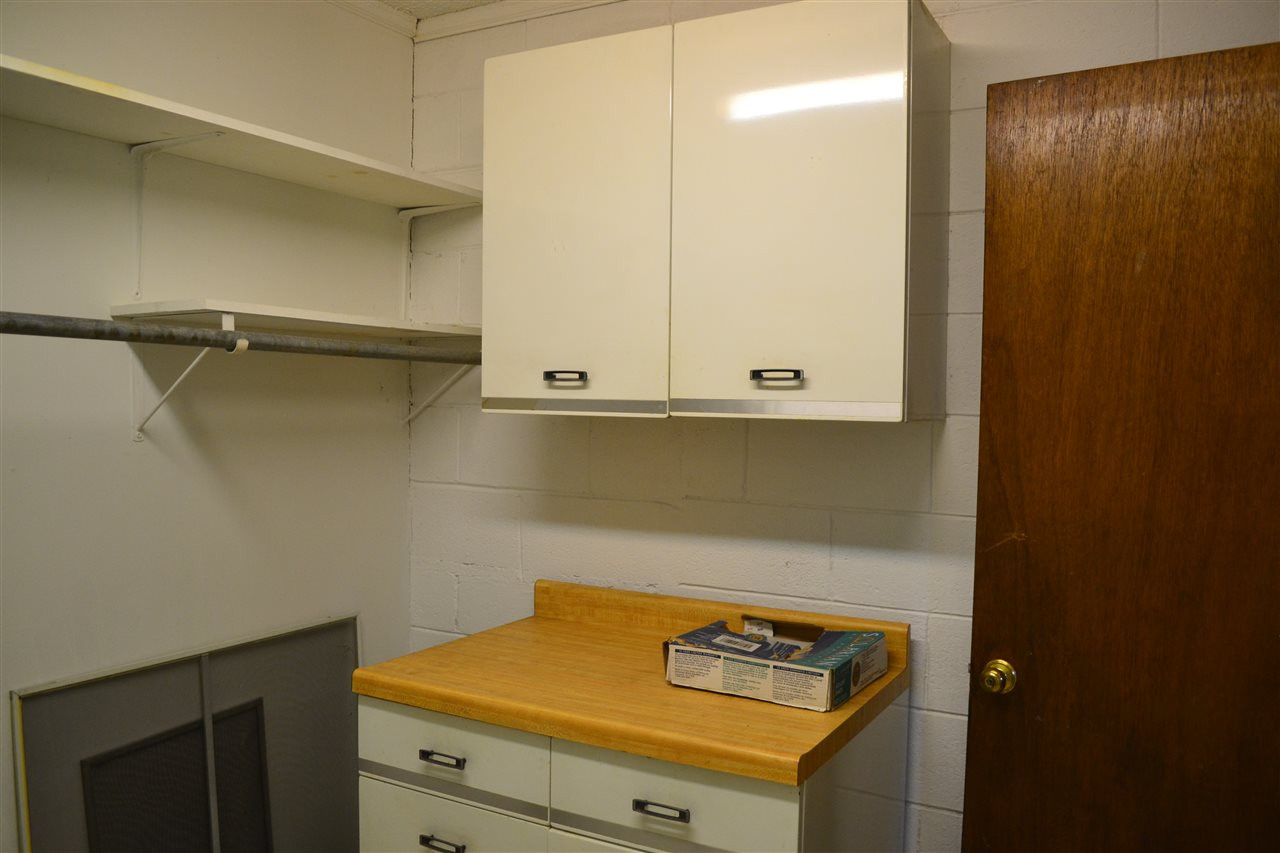 4711 Bragg Road Durham, NC 27704 - Photo 15 of 25 Large Laundry with lots of cabinets and shelves. Easy access to the hot water heater Laundry - Utility Room
