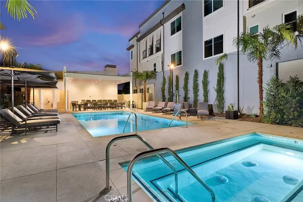 a view of a patio with swimming pool table and chairs