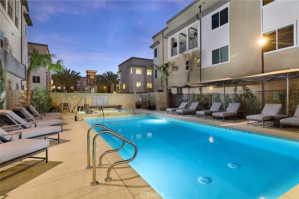 a view of a swimming pool with outdoor seating and a buildings