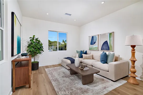 a living room with furniture and a potted plant