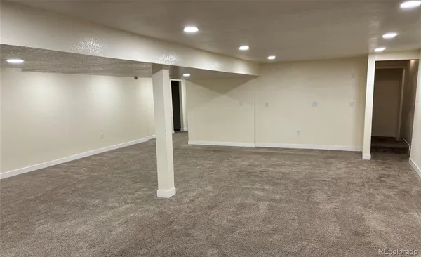 an empty room with an empty space and wooden floor