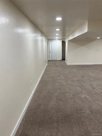 a view of hallway with an empty room