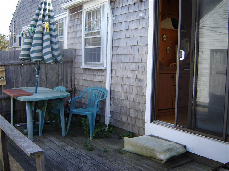 172 Captain Chase Road, Unit 3 Dennis Port, MA 02639 - Photo 6 of 10 a wooden bench sitting in front of a building