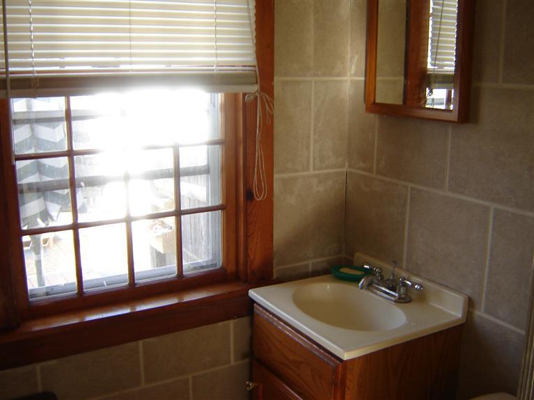 172 Captain Chase Road, Unit 3 Dennis Port, MA 02639 - Photo 8 of 10 a bathroom with a sink and a window